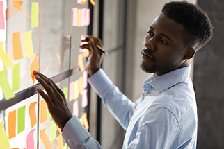 Black student using notes on a board