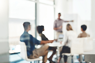 Focus on making a success of the day - stock photo. Defocused shot of a group of businesspeople having a meeting in an office